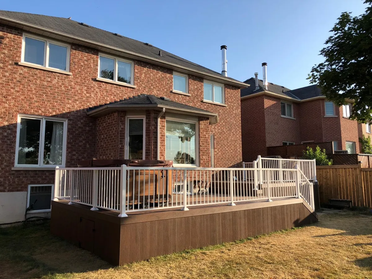 Recent Northern Deck project: composite deck with white aluminum railings and hot tub
